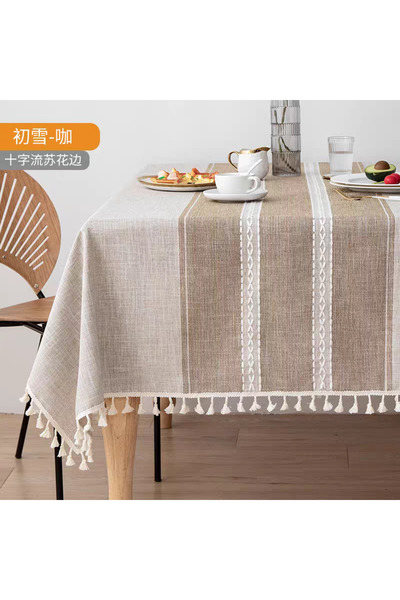 bity thok A luxurious linen dining tablecloth in beige with a modern decorative design and scalloped edges.