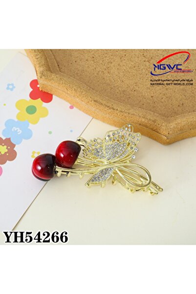 KAZUKO A gold hair clip with a butterfly and cherry design, studded with crys...