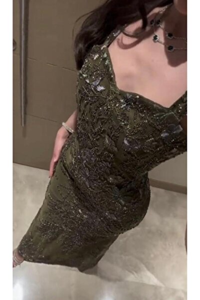 RUANI BIUTI An olive-green evening dress with feminine embroidered details.