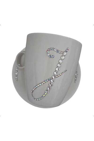 by Alexandra Vacarusi Cup and saucer set decorated with Crystals, initial J, 540ml, by Alexandra Vacarusi