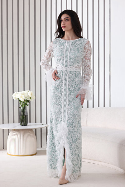Verona Trading Company A white evening dress with an elegant pattern, long lace sleeves, and a stylish front Slit .