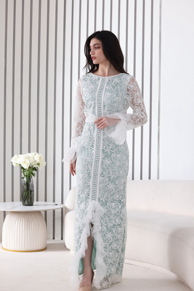 Verona Trading Company A white evening dress with an elegant pattern, long lace sleeves, and a stylish front Slit .