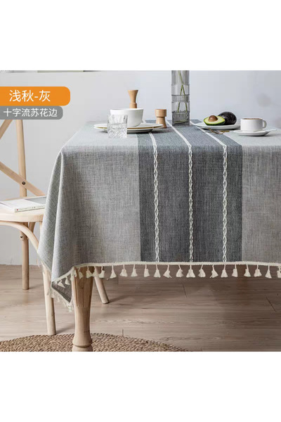 bity thok A luxurious gray linen dining tablecloth with a modern design featuring wicker edges.