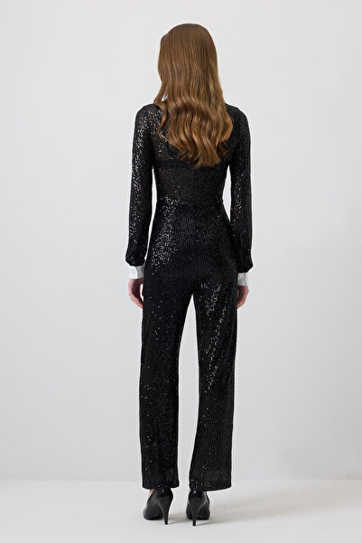 Touché Privé Jumpsuit with Front Patch, Sequin Detail, and Tulle.