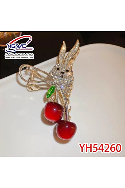 KAZUKO A hair clip with a rabbit and cherry design, studded with crystals.