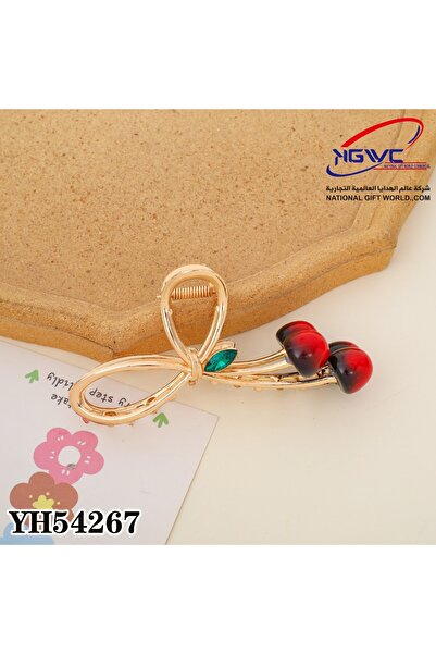 KAZUKO Gold hair clip with a cherry design and a green stone.