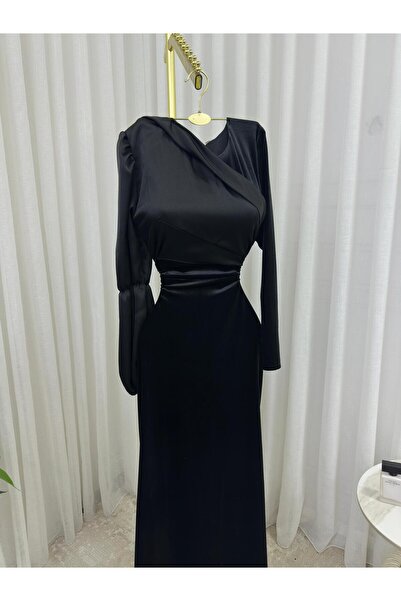 Riva A long black velvet and satin dress with long sleeves and an elegant, fitted silhouette.