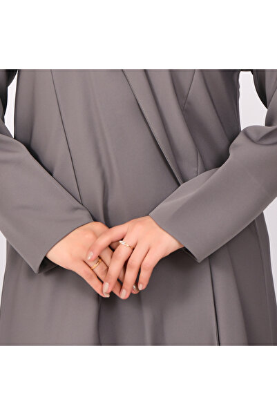HAWRAA ABAYA A practical gray wrap abaya with detailed stitching.