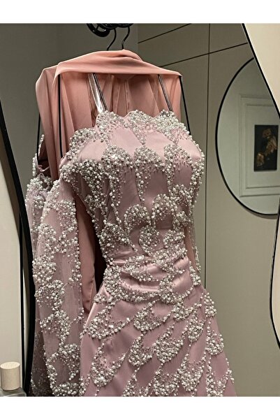 MANGONA A blush pink dress embellished with pearls, featuring a satin lining and cape sleeves, perfect for elegant bridal occasions.