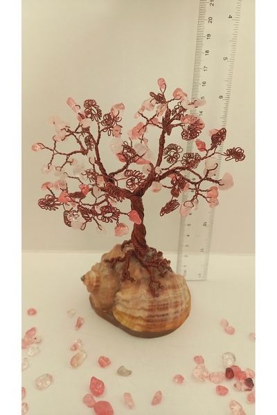 Cristaltree Decorative tree made of rose quartz crystals and cherry quartz on a sea snail