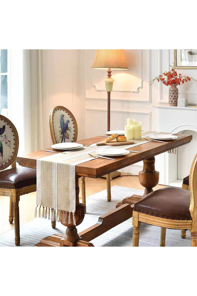 bity thok A luxurious dining tablecloth with a unique embroidered design in beige and elegant scalloped edges.