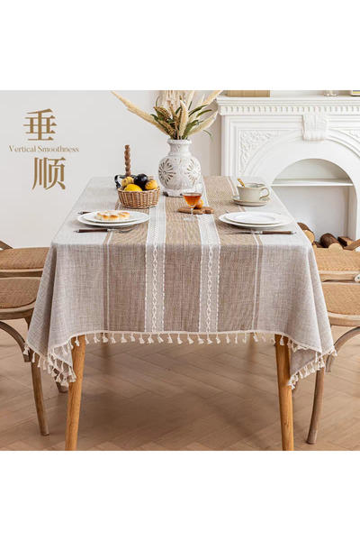 bity thok A luxurious linen dining tablecloth in beige with a modern decorative design and scalloped edges.