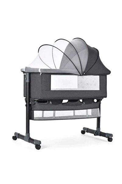 KM Next2me newborn baby crib with safety wheels, mosquito net, and foldable rocker