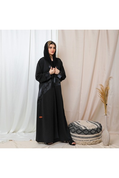 Leatherthreads A luxurious black abaya made of soft silk with delicate embroidery along the edge.