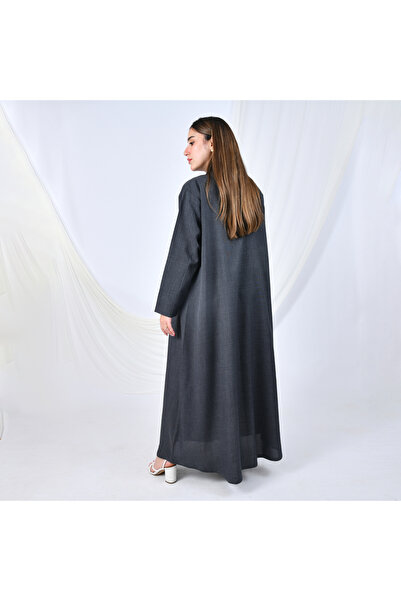 HAWRAA ABAYA A gray abaya with a simple, formal design and a quarter-circle cut, adorned with flower-shaped buttons that add a feminine touch.