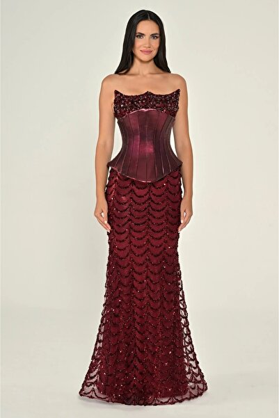 ALFABETA A long, strapless dress with a corset waist and sequin embellishments.