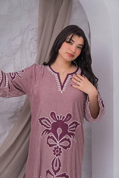 AFandina A linen jalabiya with intricate details that adds a touch of luxury