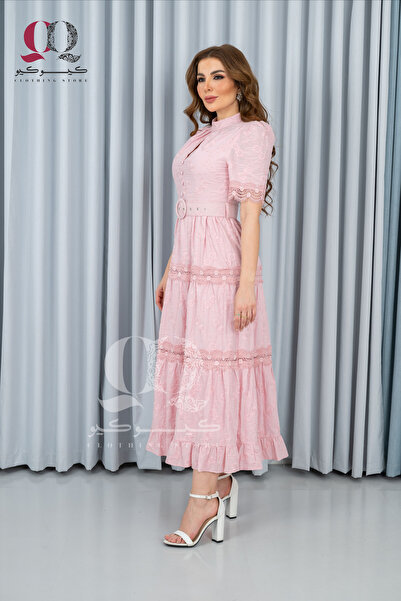 Aljouri An elegant pink dress with a sophisticated, feminine design, combining softness and luxury with lace details and decorative pockets.