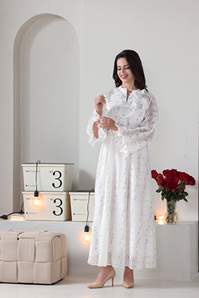 Verona Trading Company Luxurious white lace maxi dress with wide, embellished sleeves and a front ruffle, complete with a matching belt.