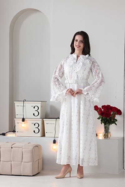 Verona Trading Company Luxurious white lace maxi dress with wide, embellished sleeves and a front ruffle, complete with a matching belt.