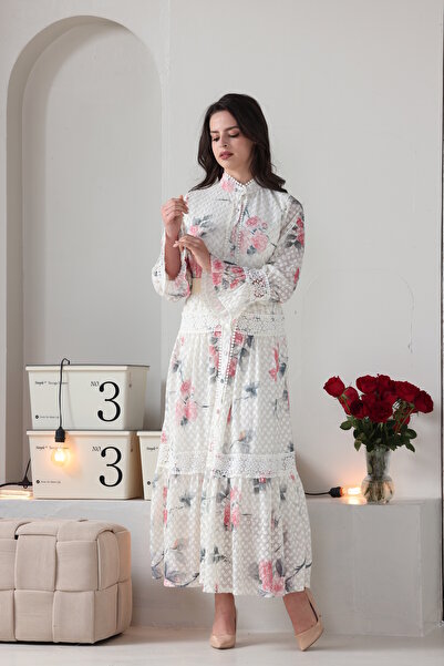 Verona Trading Company Verona maxi dress with puff sleeves, floral print, and tulle fabric lined with a geometric pattern.