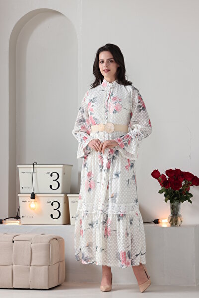 Verona Trading Company Verona maxi dress with puff sleeves, floral print, and tulle fabric lined with a geometric pattern.