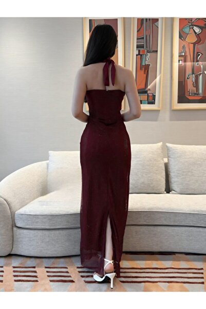 Generic A fitted evening dress (sheath) in burgundy with a halter neckline.
