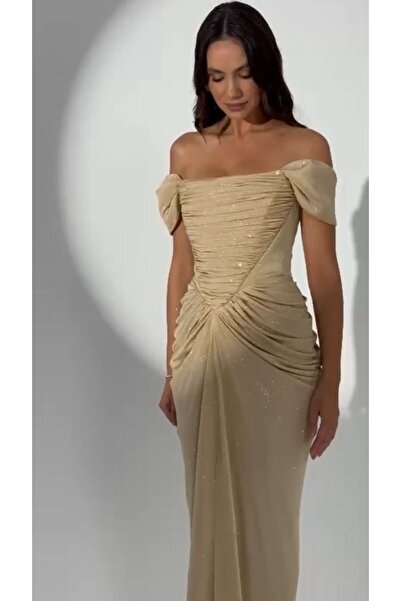 ALFABETA A shimmering evening gown with off-the-shoulder sleeves and an elegant draped silhouette, paired with a shawl.