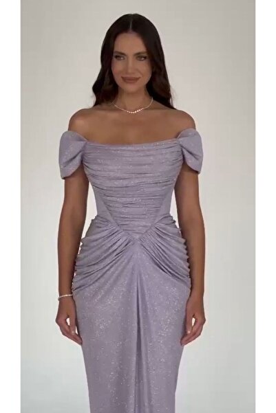 ALFABETA A shimmering evening gown with off-the-shoulder sleeves and an elegant draped silhouette, paired with a shawl.