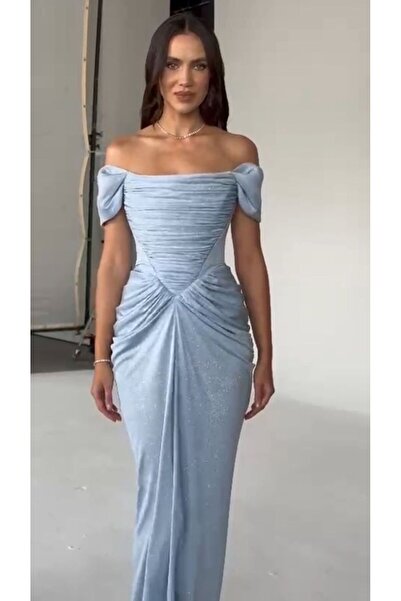 ALFABETA A shimmering evening gown with off-the-shoulder sleeves and an elegant draped silhouette, paired with a shawl.