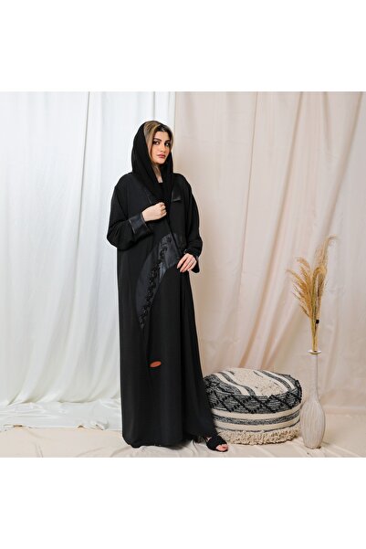 Leatherthreads A luxurious black abaya made of soft silk with delicate embroidery along the edge.