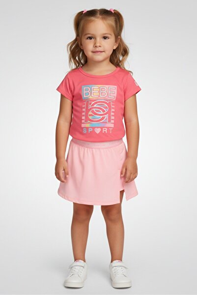 Bebe طقم ملابس رياضية للبنات مكون من قطعتين، تي شيرت وتنورة قصيرة بأكمام قصيرة، باللون الوردي