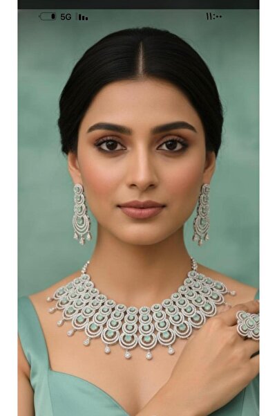 SS A silver zircon set with navy blue stones. The set consists of a necklace, earrings, and a ring.