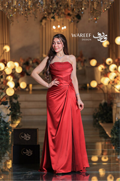 WAREEF FASHION A royal red evening gown with luxurious draping details and an embroidered mesh corset.