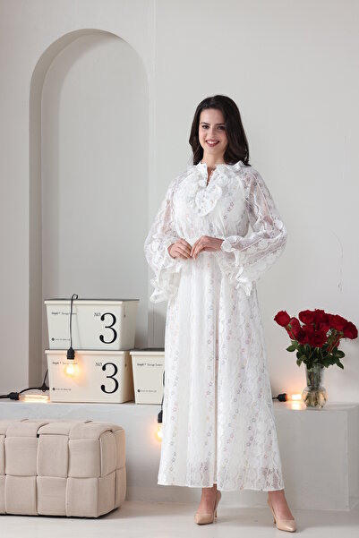 Verona Trading Company Luxurious white lace maxi dress with wide, embellished sleeves and a front ruffle, complete with a matching belt.