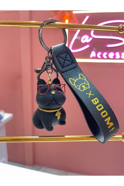 La She Accessories سلسلة مفاتيح من السيراميك باللون الأسود مع شكل كلب يرتدي ن...