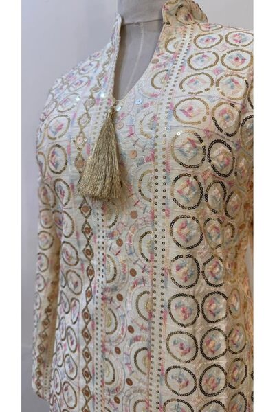 ISHRAQAT AL-AMAL A kaftan or jalabiya fully embroidered with gold circles