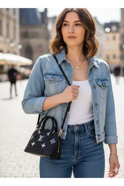 Generic A small black bag with white patterns and a thin shoulder strap, simple elegance suitable for the city.