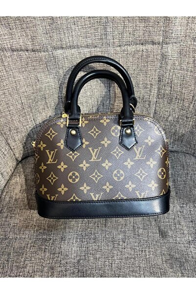 Generic A domed handbag in brown and black, with a classic pattern and elegant top handles.