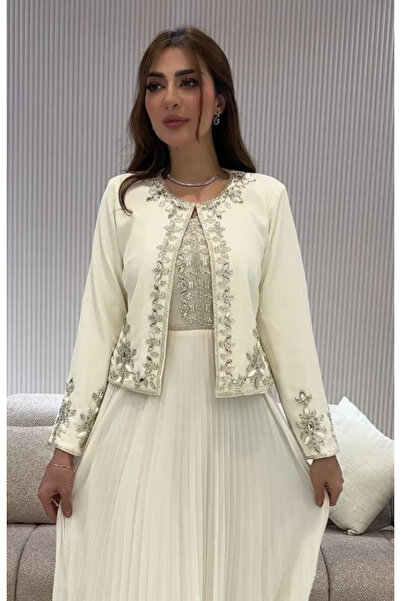 Vitrina A dress with a flowing pleated skirt and a short jacket embroidered with shimmering silver crystals.