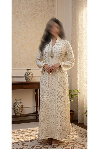 ISHRAQAT AL-AMAL A kaftan or jalabiya fully embroidered with gold circles