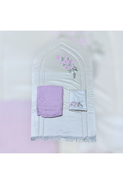 FABRIC A white rug with pink embroidery and a pink prayer set create a harmon...