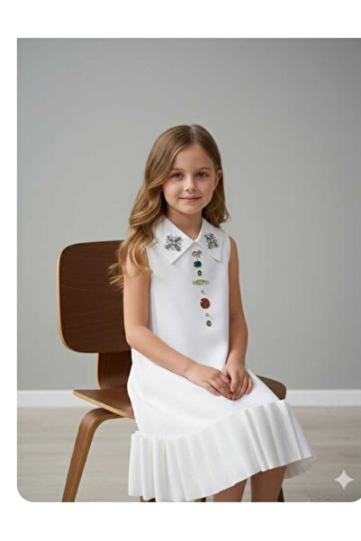 gmax A girl's dress decorated with colorful stones and embellishments, and with a ruffled hem.