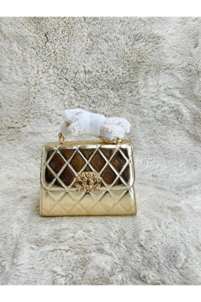 Generic A small, quilted shoulder bag in a shimmering gold color. An iconic piece that adds luxury and dazzling appeal to your style.