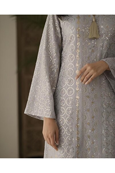 ISHRAQAT AL-AMAL A kaftan or jalabiya fully embroidered with gold circles