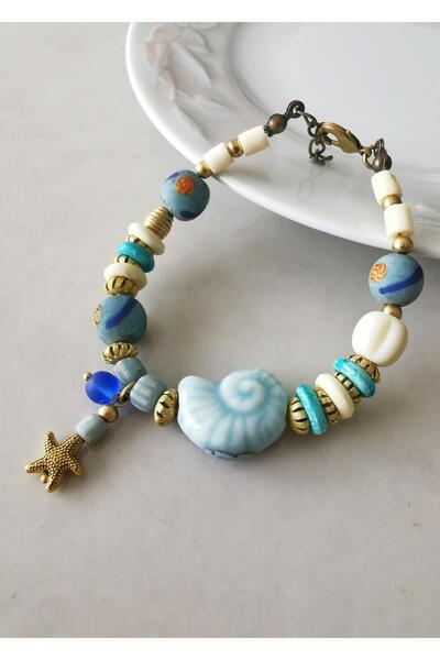 Halley Concept سوار نسائي بتصميم خاص مصنوع من السيراميك على شكل قشرة الحلزون