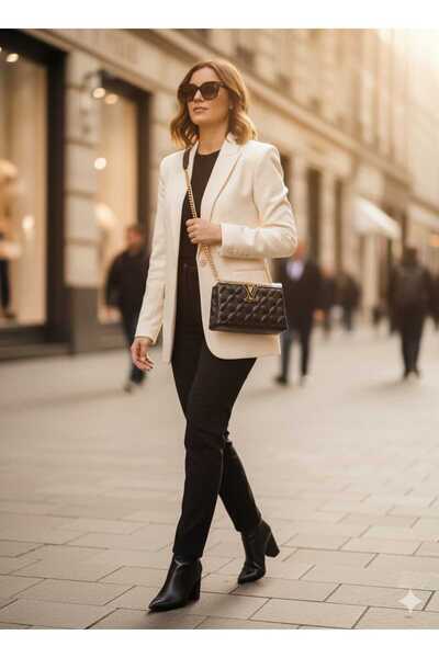 Generic A black bag with a quilted texture and a gold chain adds luxury, suitable for a formal and modern look.