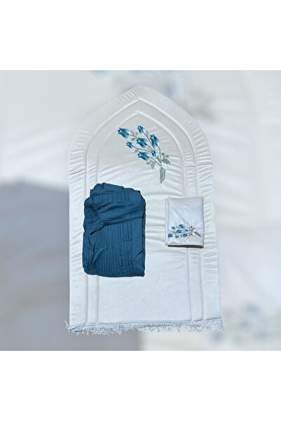 FABRIC A white rug with sky blue embroidery, along with a dark sky blue praye...