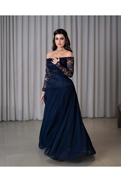 Riva A navy blue evening dress with a classic and elegant design. It features a lace bodice.