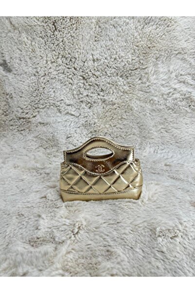 Generic A small, shimmering gold handbag with a quilted design and a cut-out handle. A luxurious piece to brighten up your evening look.